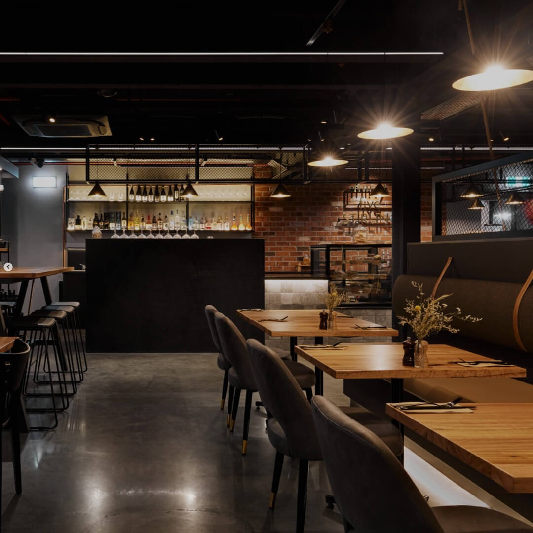 Modern industrial-style café interior with ambient lighting and timber furniture at Thirty Five Stirling, Thebarton.