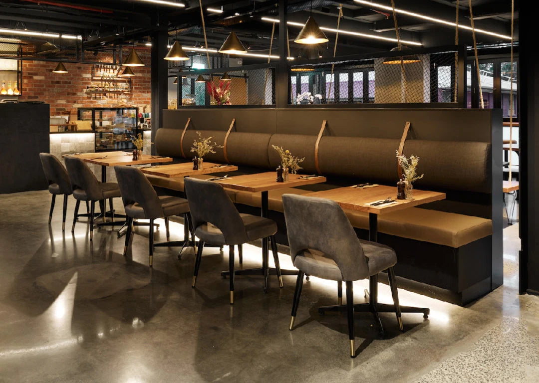 Stylish dining area inside Thirty Five Stirling café in Thebarton, Adelaide, featuring timber tables, moody lighting, and industrial-chic interior design.