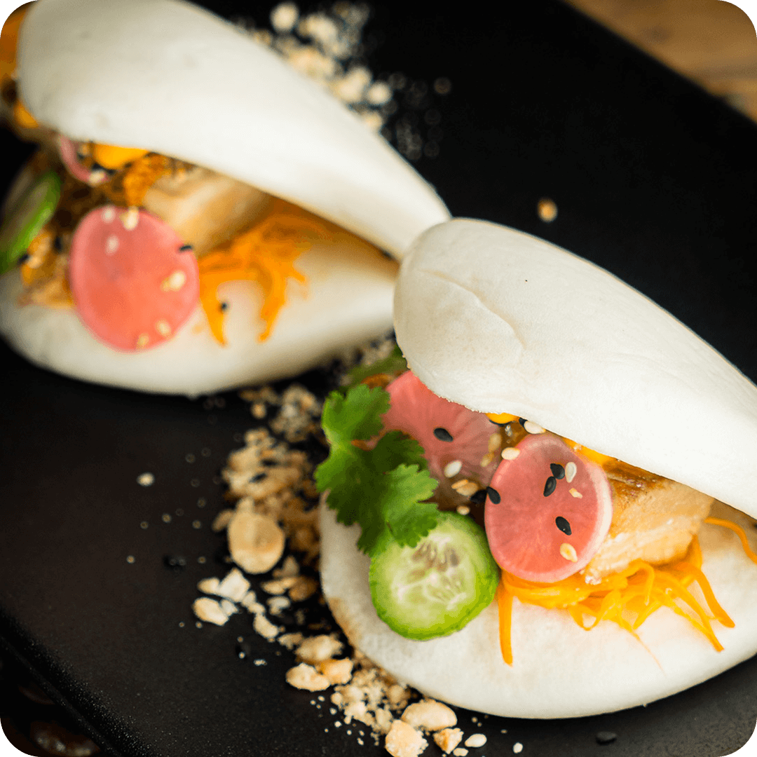 Steamed bao buns with crispy chicken, pickled vegetables, and sesame at Thirty Five Stirling café in Adelaide.